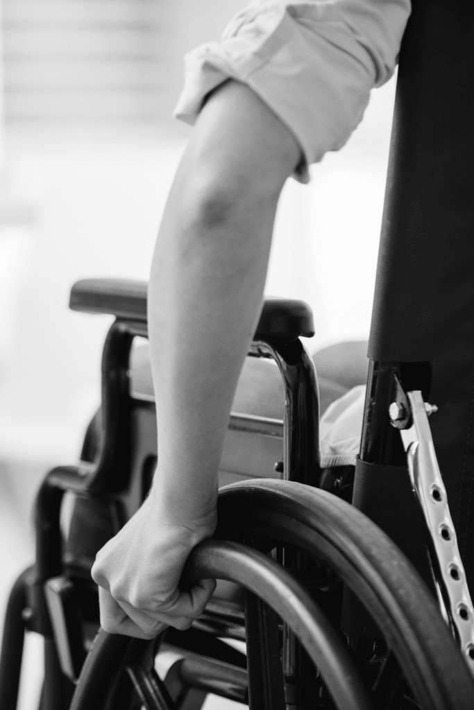 person in wheelchair (close up of person pushing themselves in chair)